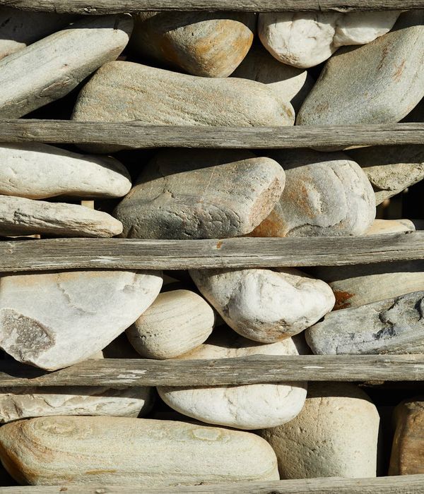 A collection of smooth jade-colored stones stacked together